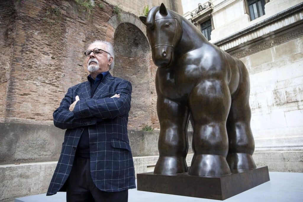 Fernando Botero next to his monumental bronze sculpture of a horse, one of his most internationally recognized works.