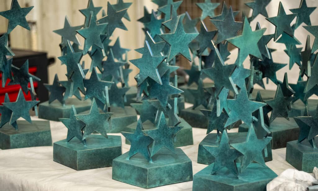 Seven Stars of Sport trophies in bronze in the shape of stars, made by Capa Esculturas for sporting awards.<br>