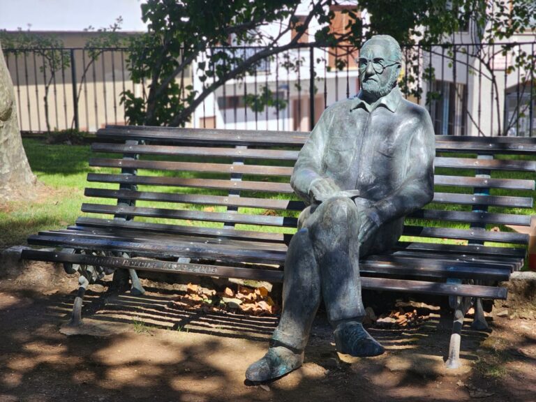 Restored sculpture of Antonio Pereira seated on a bench in the Alameda Garden, Villafranca del Bierzo.