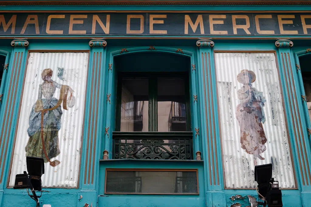 Front of an old centenary store in Madrid, decorated with a commemorative plaque.
