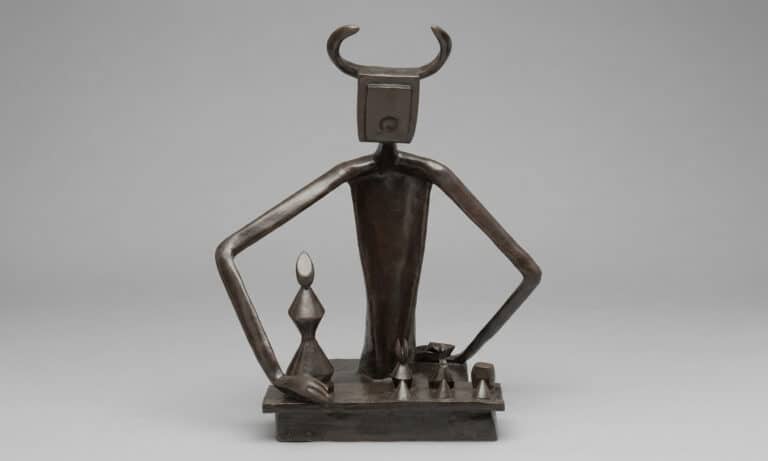 El rey jugando con la reina de Max Ernst, escultura surrealista con figuras totémicas, arte simbólico y formas primitivas en bronce.
